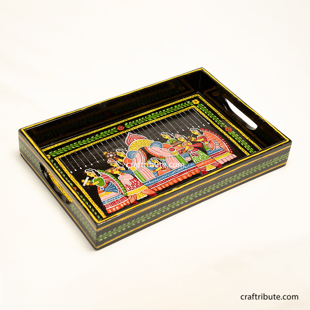 Hand painted wooden tray with an intricate design depicting an indian bride being carried in a paliquiin. Best suited for everyday as well as festive occassions.