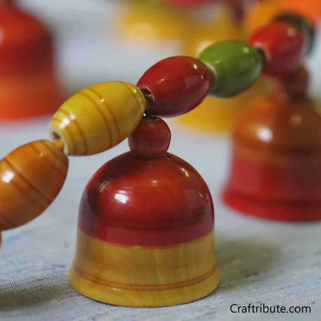 Close up of handcrafted Lacquer finished Wooden Toran with colourful Bells and beads from Etikoppakka, Andhra Pradesh