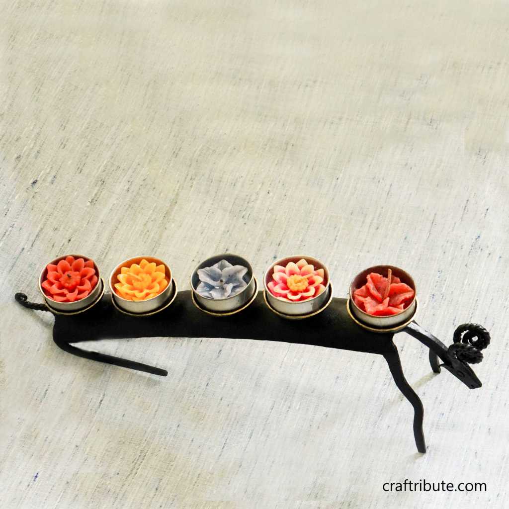 two Wrought Iron Medha (Aries) design candle stands with decorative candles made by tribal artisans from Bastar, Chhattisgarh
