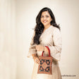 Girl carrying a handbag with Scorpio (Vicchi) design in Kutch 'Neran' Embroidery style, in attractive Red & Black combination