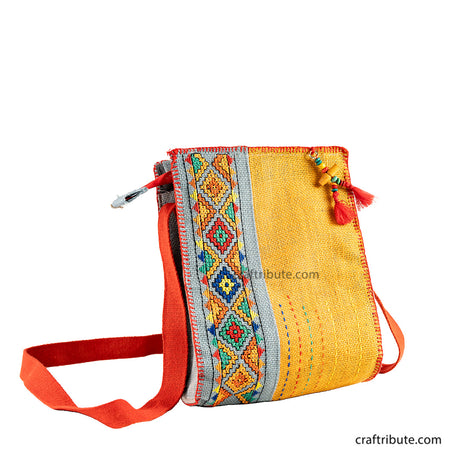 Front side of hand embroidered Yellow & Grey jute sling bag with red belt