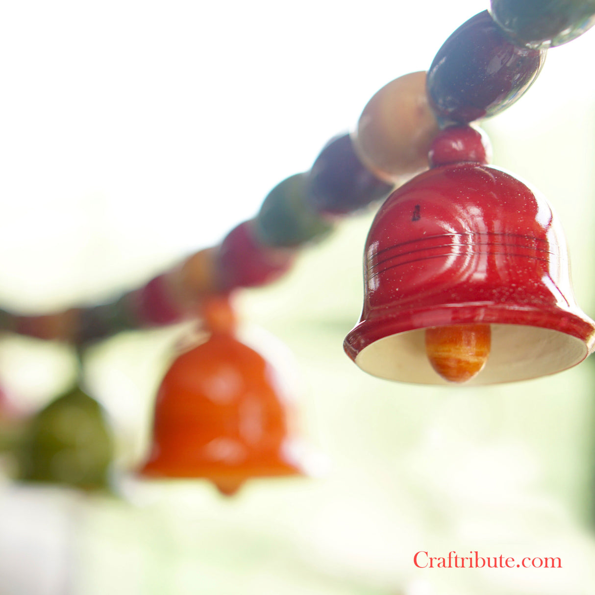Lacquer finished wooden Toran in vibrant red and orange colours