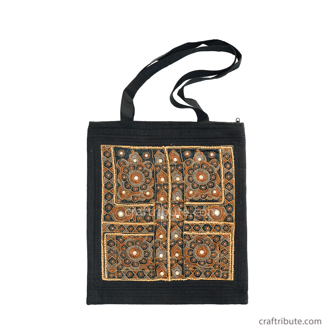 Front side of a tote bag embellished with Sindhi Memon style of Kutch hand embroidered in red & green colours