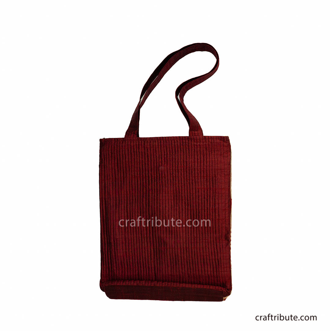 Back of red tote bag having Ahir Kutch hand embroidery with floral design in Black, Grey & Gold