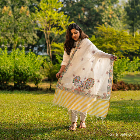 A beautiful piece of Madhubani cotton silk dupatta hand painted by skilled artisans from Bihar worn by a lady.