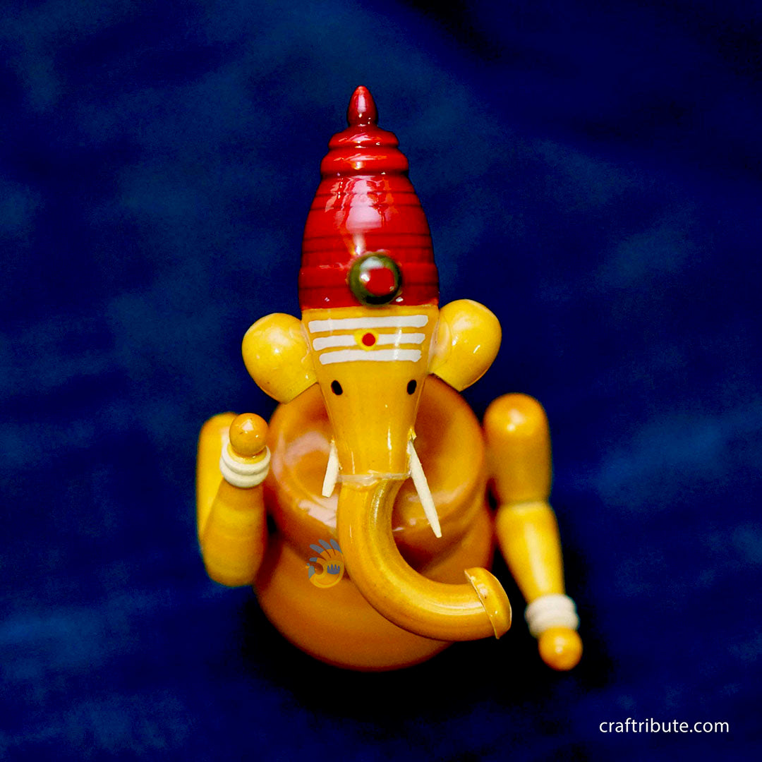 Handcrafted laquer finished Wooden Ganesha idol in organic Yellow colour from Etikoppaka