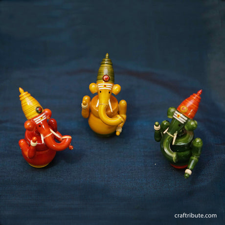 Handcrafted laquer finished Wooden Ganesha set in organic Red, Yellow and Green colours from Etikoppaka