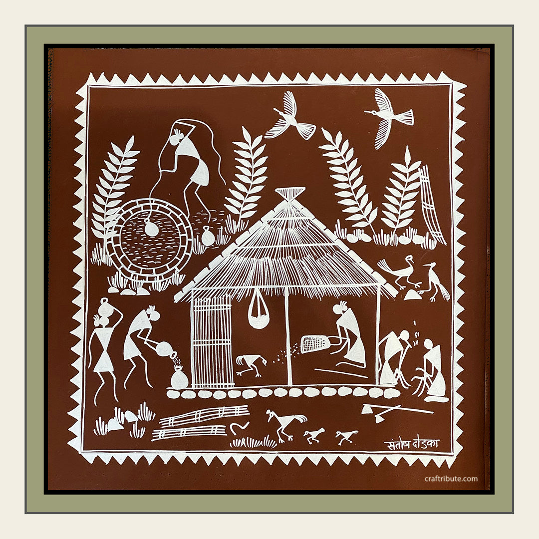 A square-framed Warli Painting depicting a village scene. Women doing household chores; men enjoying a quiet moment.