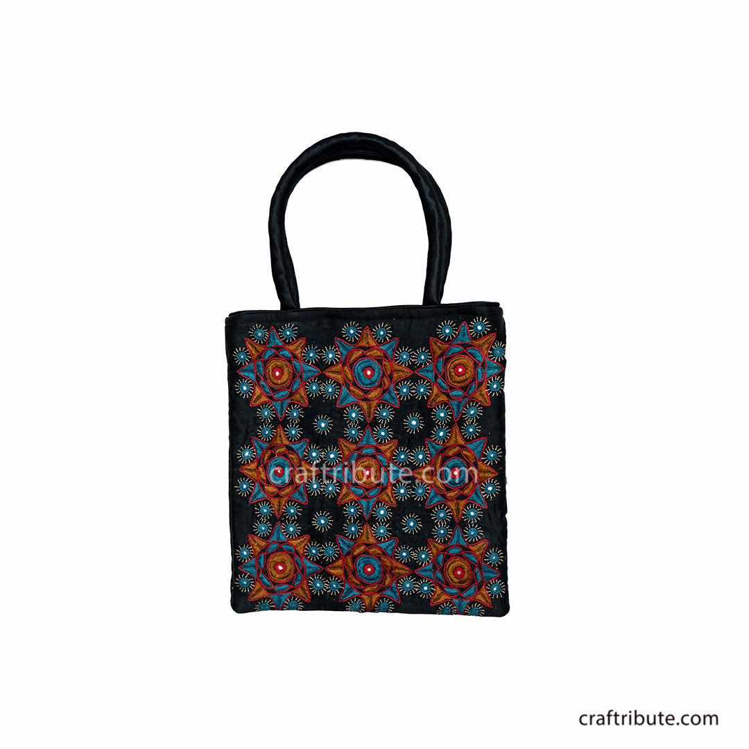 Front side of a beautiful black hand bag with Pakko Kutch Hand Embroidery with 9 stars design in Orange & blue colours