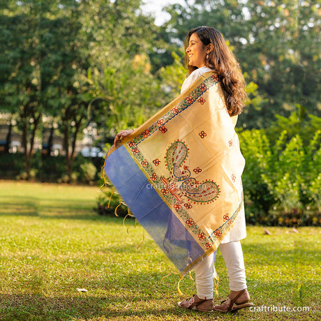 Side view of Madhubani hand painted dupatta with blue border and peacock and floral design