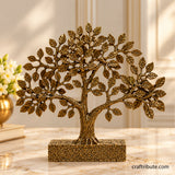 Handcrafted antique gold brass Bodhi tree sculpture with intricately detailed leaves, a textured trunk, and a decorative rectangular base, displayed on an elegant marble tabletop.