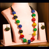 Colorful beaded necklace and earrings made from upcycled fabric waste, on a mannequin bust with 'crafttribute.com' branding.