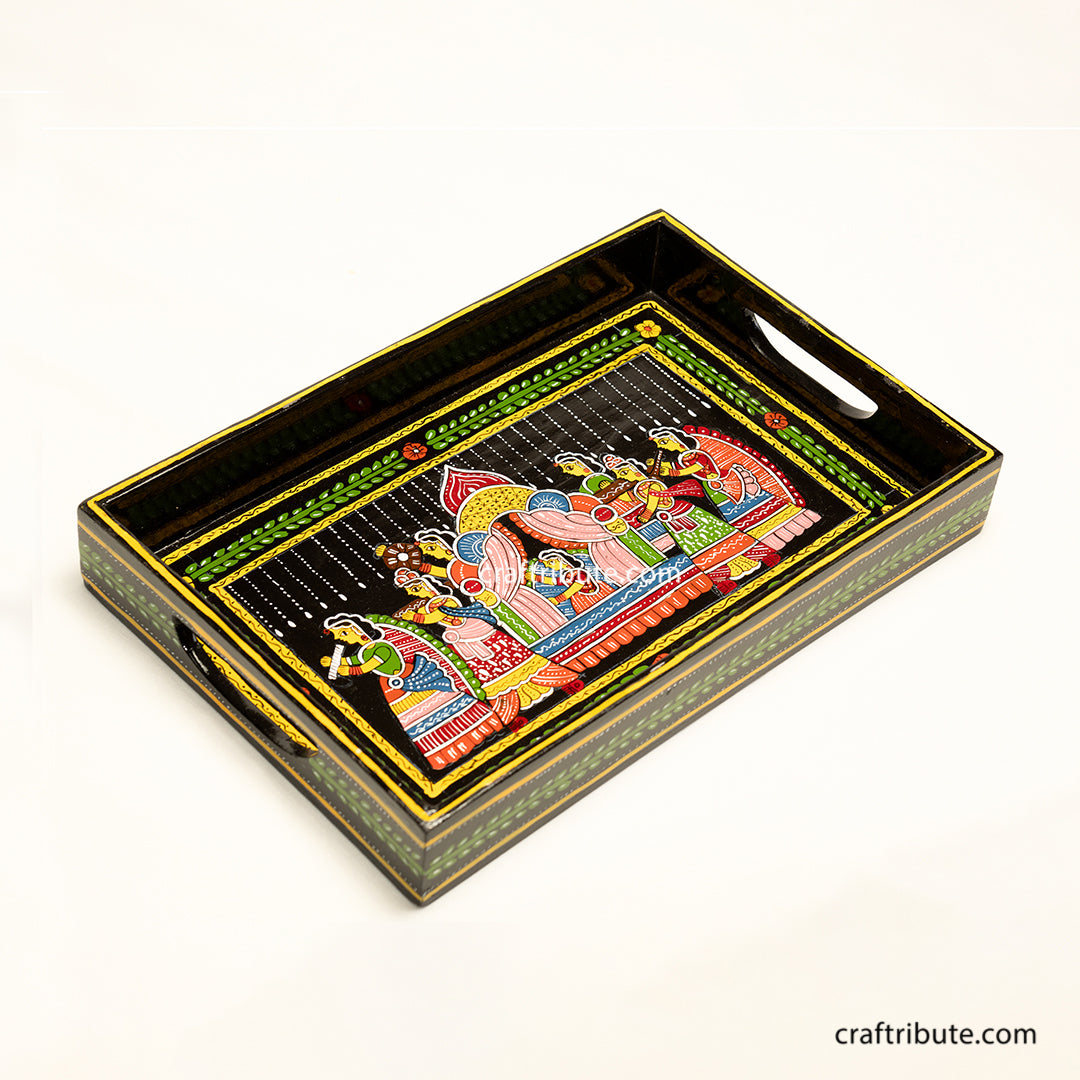Hand painted wooden tray with an intricate design depicting an indian bride being carried in a paliquiin. Vibrant colours on a black surface makes it very festive and a beautiful gifting option for wedding ceremonies.