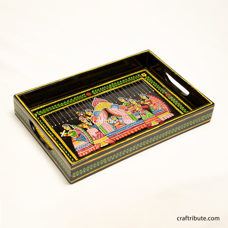 Hand painted wooden tray with an intricate design depicting an indian bride being carried in a paliquiin. Best suited for everyday as well as festive occassions.