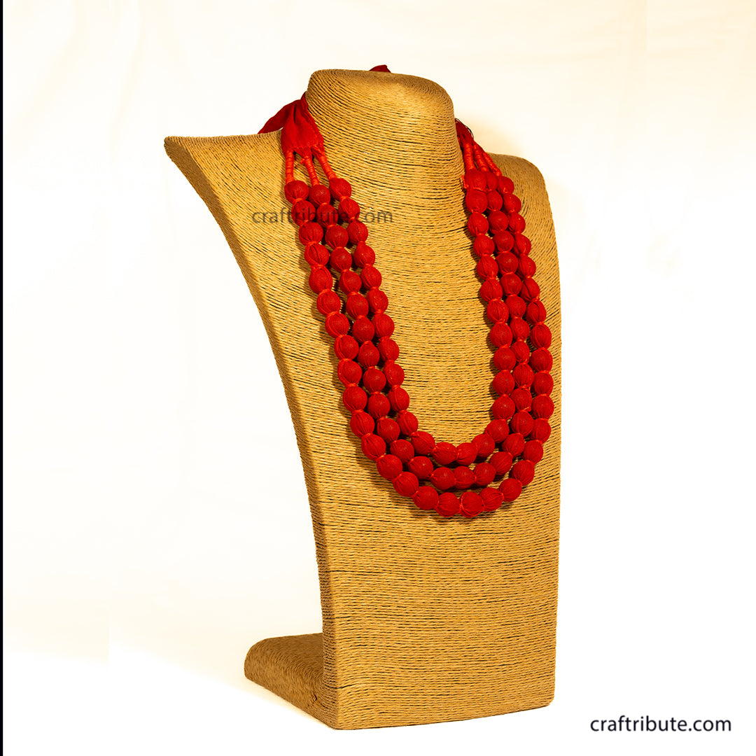 Red beaded necklace on a brown mannequin bust with 'crafttribute.com' branding.