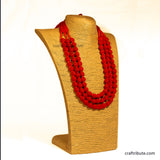 Red beaded necklace on a brown mannequin bust with 'crafttribute.com' branding.