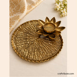 Handcrafted brass lotus leaf tray with a matching lotus diya holder, featuring intricate detailing and an antique gold finish, ideal for festive décor and Diwali gifting.