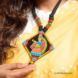 Close up of Tikuli Art Pendant with a Milkmaid hand painted in traditional style by grass root artisans from Patna, Bihar