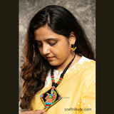 A girl wearing hand painted Tikuli Art pendant and a pair of Bird Shape earrings in detail