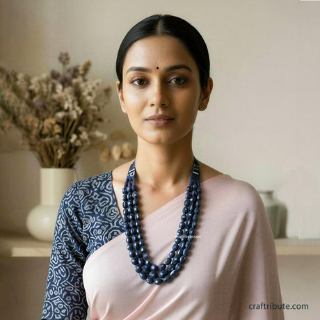 A lady wearing upcycled indigo fabric necklace 
