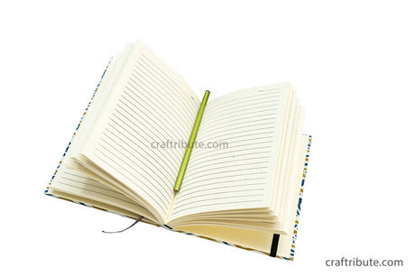 Inside view of the handmade paper notebook from Craftribute with ruled pages and elastic band