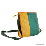 Back side of hand embroidered Yellow & Green jute sling bag with dark green belt