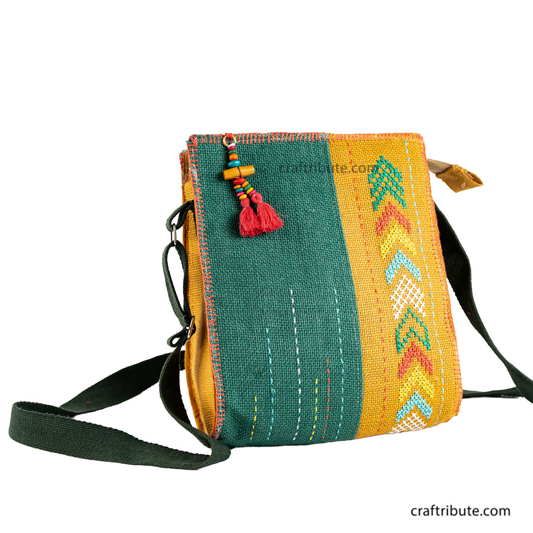 Front side of hand embroidered Yellow & Green jute sling bag with dark green belt