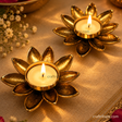 Lotus T Light  Holders with candles on festive linen and flowers 