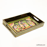 Decorative tray with intricate design depicting a wedding scene on a black background. Hand-painted by women artists from Patna, Bihar, this tray belongs to the beautiful handicraft tradition of Tikuli Art.