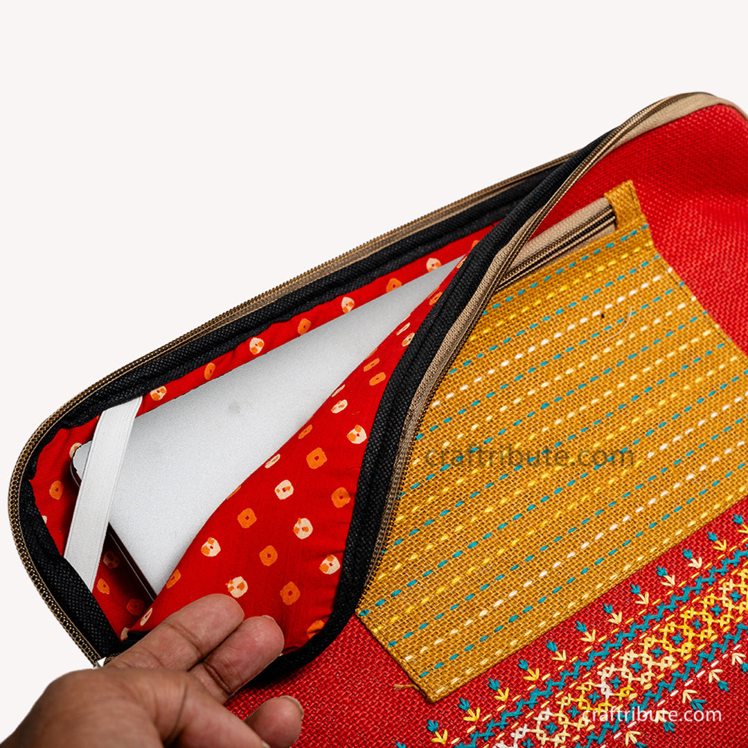 inside view of hand embroidered 15" laptop sleeve made from eco friendly jute material showcasing the soft padding and elastic corner for additional safety