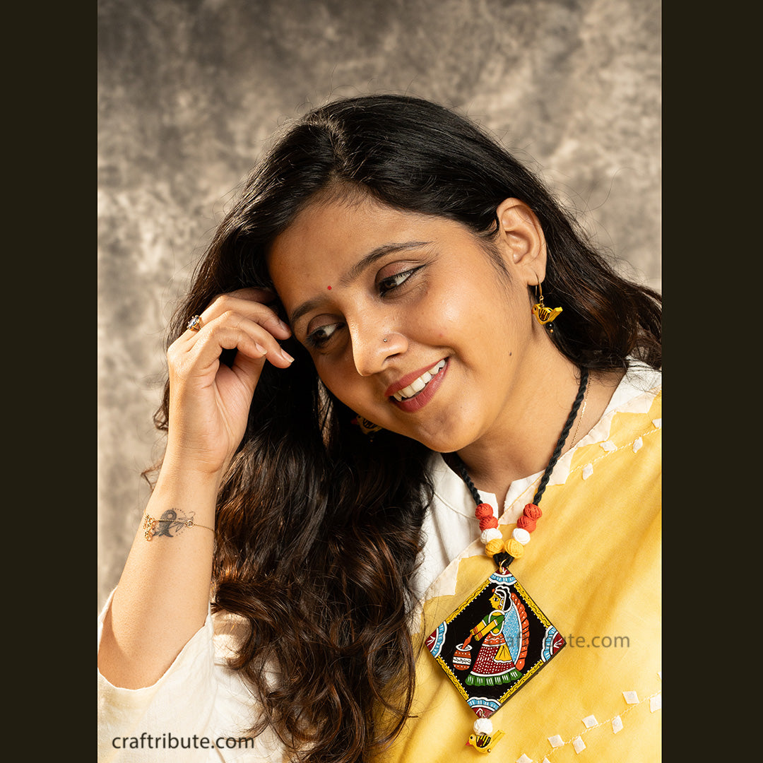 Hand painted Tikuli Art pendant in Black thread and attractive combination of yellow, white & red thread beads and matching wooden earrings in bird shape