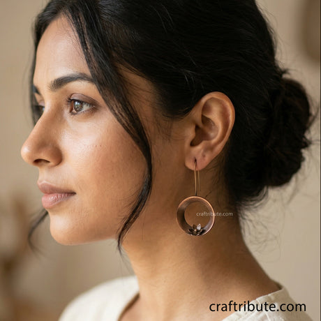 Lady wearing classic looking handcrfated copper earrings with flower