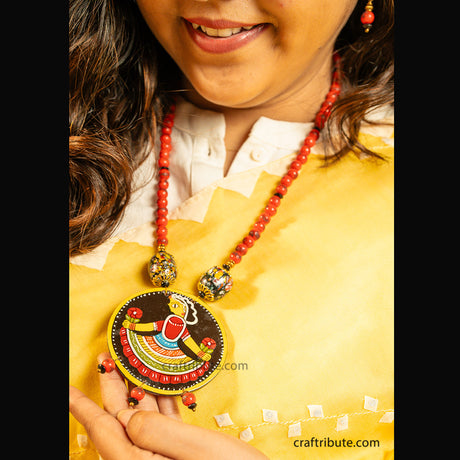 Close up of Tikuli Art Jewellery set with hand painted wooden Pendant and matching earrings