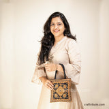 Model with a handbag with Scorpio (Vicchi) design in Kutch 'Neran' Embroidery style, in eye catchy Black & Orange combination 