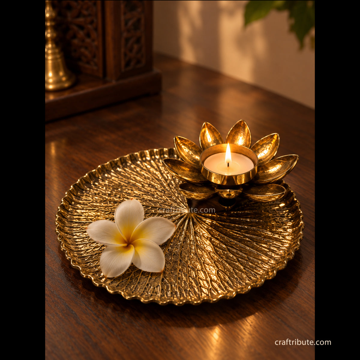 Handcrafted brass lotus leaf tray with a lotus diya , Lotus Diya holds a Tea Light Candle and the tray has a beautiful champa flower