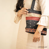 Girl holding a Kutch Khudi Sebha, Hand Embroidered Tote Bag with Black & Beige stripes