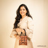 Pakko (Kutch Embroidery) handbag with floral design in classy red & black colours carried by a girl