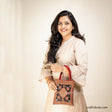 Girl carrying a handbag with Scorpio (Vicchi) design in Kutch 'Neran' Embroidery style, in attractive Red & Black combination 