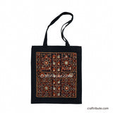 Front side of a tote bag embellished with Sindhi Memon style of Kutch hand embroidered in Black & Orange colours
