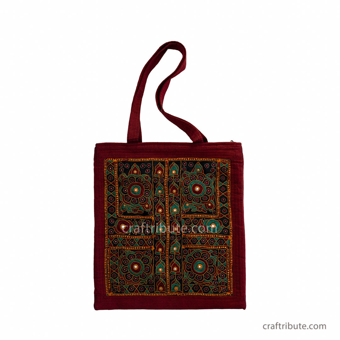 Front side of a tote bag embellished with Sindhi Memon style of Kutch hand embroidered in red & green colours