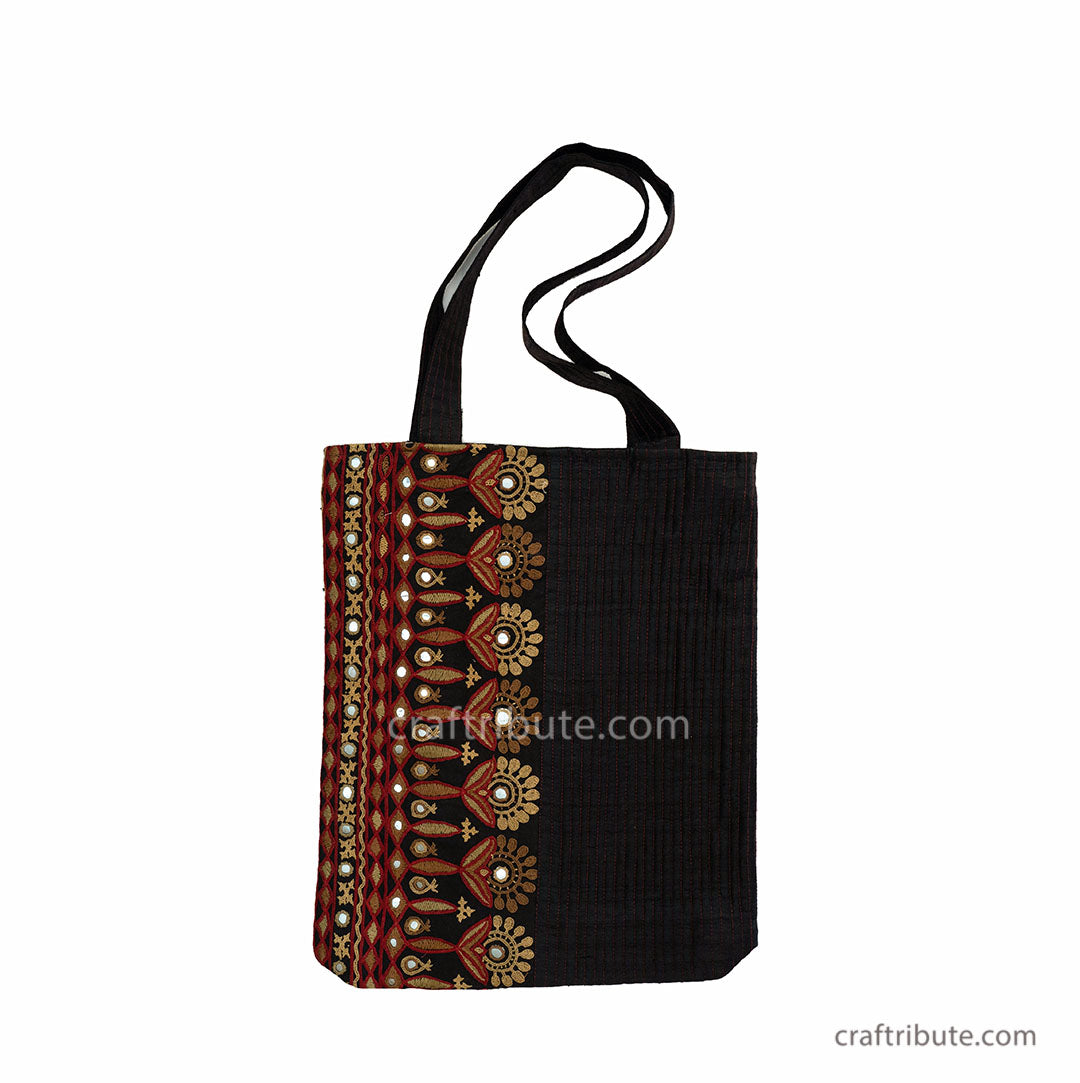 Tote bag showcasing Ahir Kutch Hand embroidery with floral design in Red & Gold