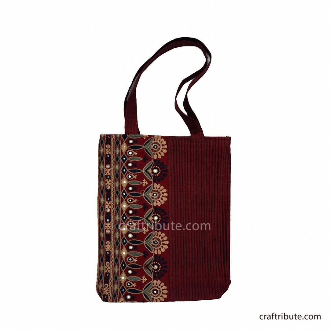 Front of red tote bag having Ahir Kutch hand embroidery with floral design in Black, Grey & Gold