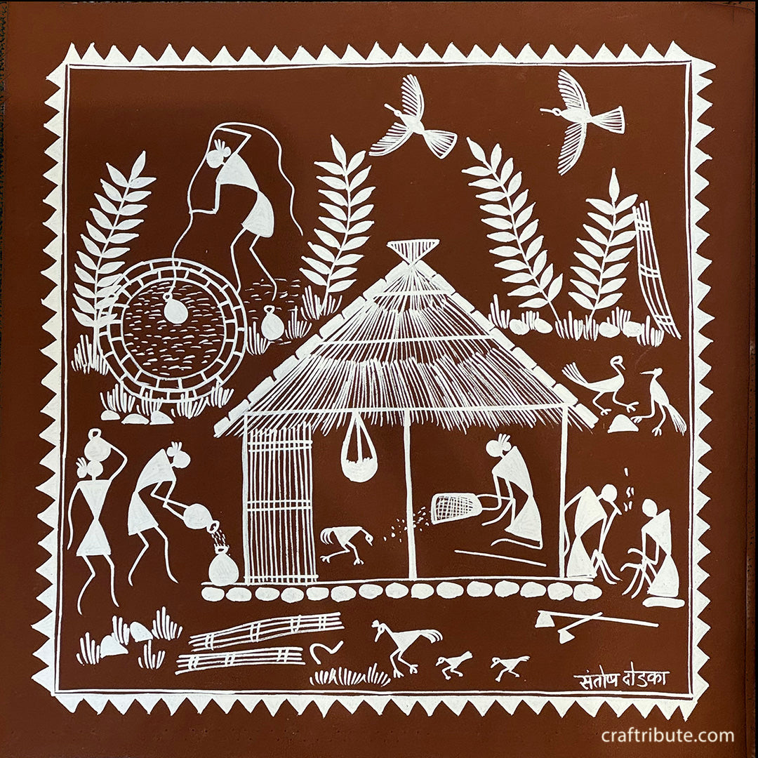 An authentic Warli Painting on a terracotta background, depicting a village scene. Women doing household chores; men enjoying a quiet moment.