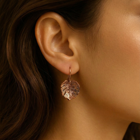 Close-up of a lady wearing a handcrafted copper Monstera leaf-inspired earring 
